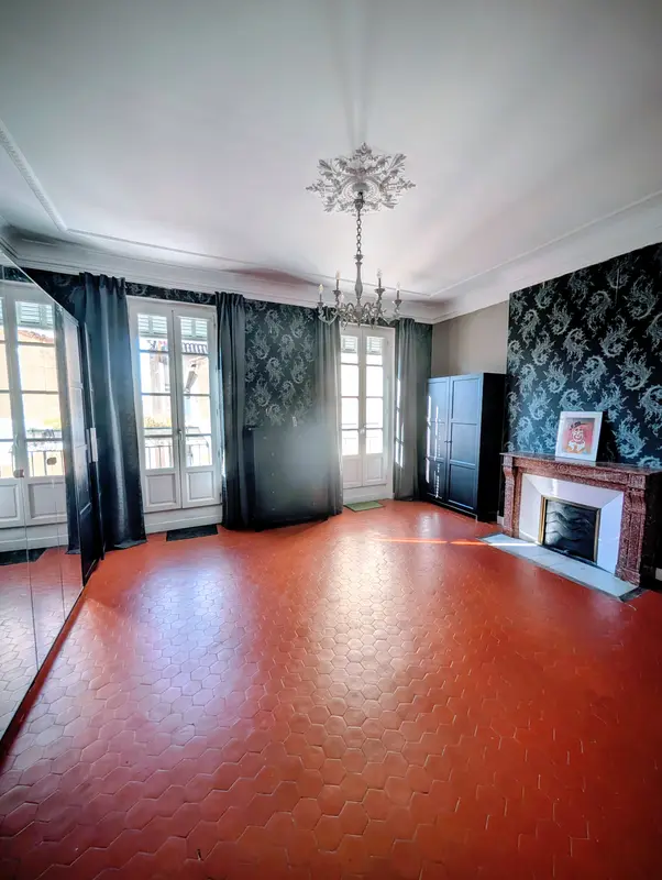 Grande chambre avec portes-fenêtres et cheminée en marbre